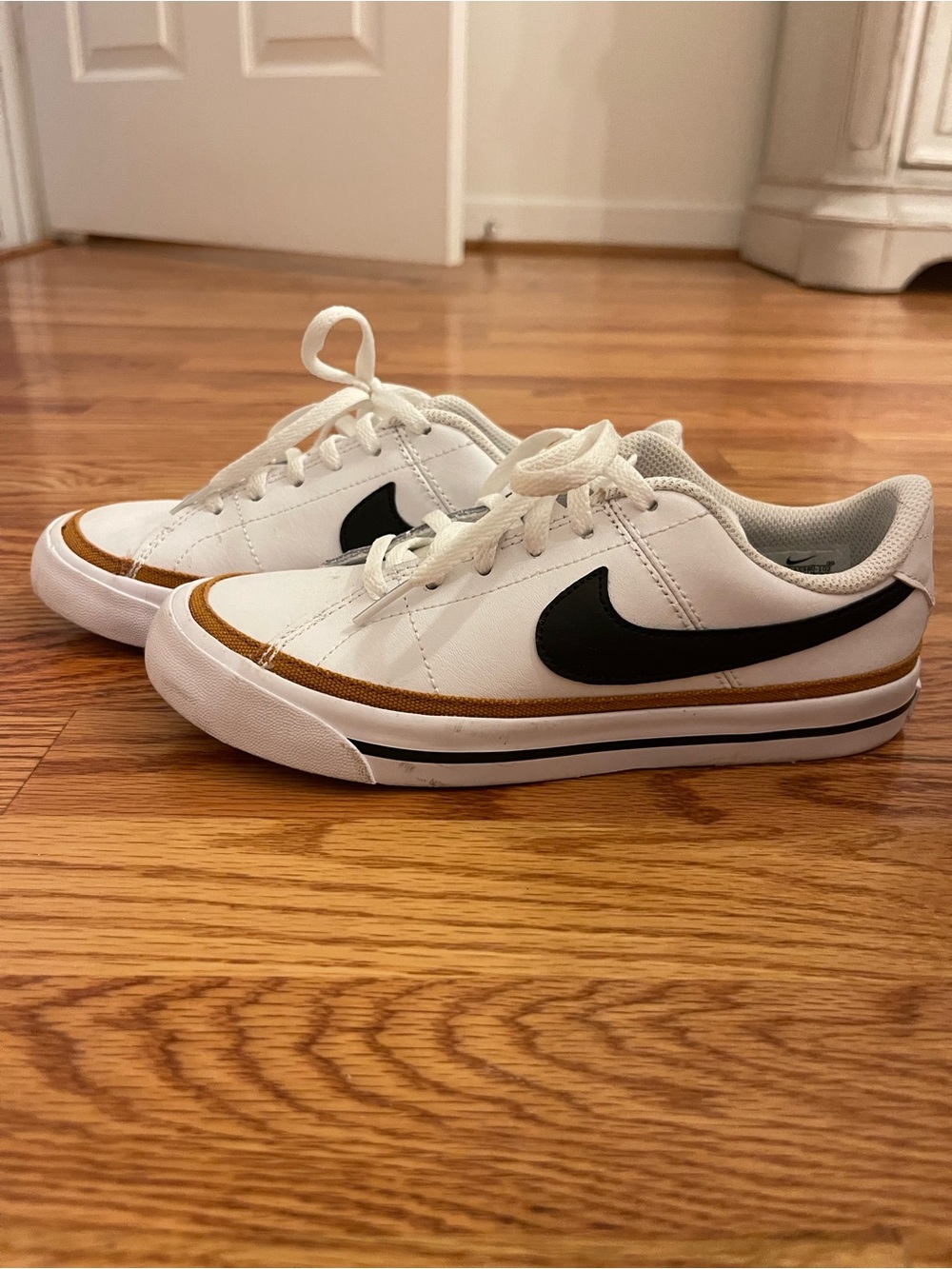 Nike Court Legacy White Low-Top Sneakers with Black Swoosh and Gold Trim